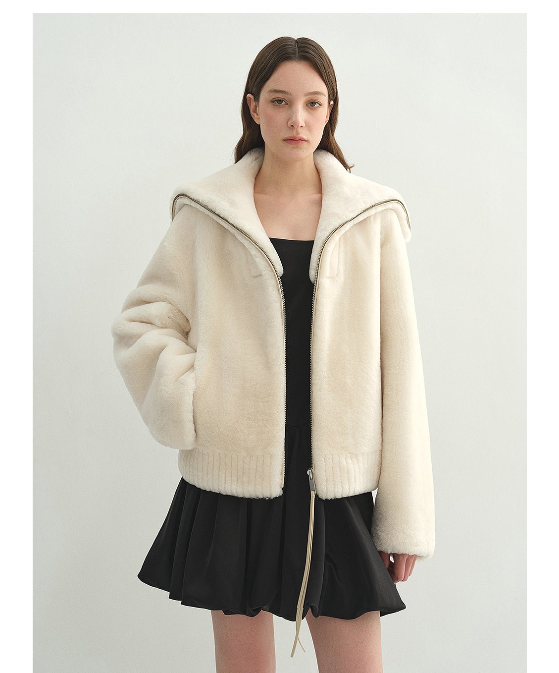 Women's shearling leather coat by Firelady Fur featuring navy merino wool blend, short style with shearling collar and leather details.