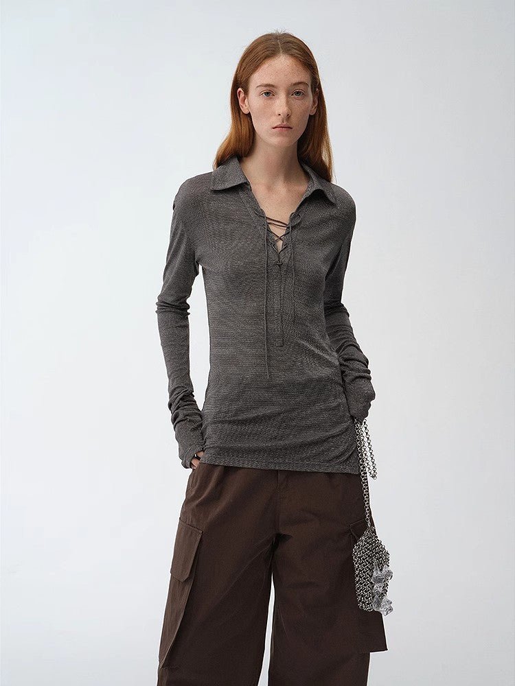 Light silver silk knitted top by Firelady Fur with a slim fit, long sleeves, tie lapel, and slightly transparent, luxurious texture.
