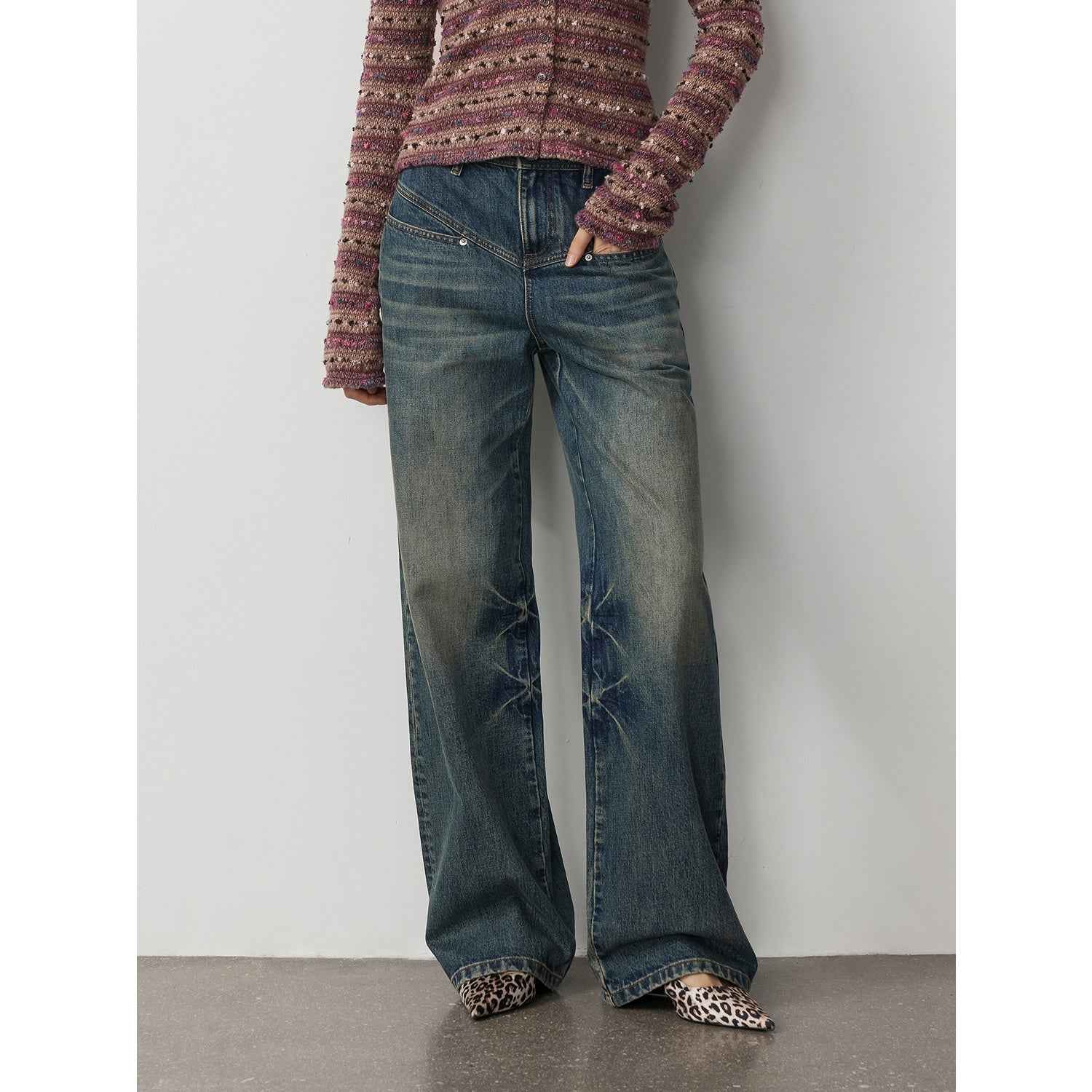Firelady Fur women's denim straight-leg trousers with distressed vintage wash, textured marble pattern, and V-shaped segmented design.